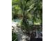The backyard is beautifully landscaped with many trees surrounding the pool and patio at 2932 Silver Ridge Dr, Orlando, FL 32818