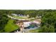 Aerial view of a home with a pool and fenced backyard with sheds for storage at 316 Amanda Ln, Leesburg, FL 34748