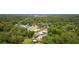 Aerial view of single-Gathering homes with a pool, set amidst lush greenery and mature trees at 316 Amanda Ln, Leesburg, FL 34748
