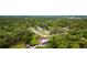 Aerial view of a charming single-Gathering home with a pool, surrounded by lush greenery and mature trees at 316 Amanda Ln, Leesburg, FL 34748