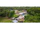 Aerial view of a home with a pool and fenced backyard with sheds for storage at 316 Amanda Ln, Leesburg, FL 34748