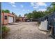 Spacious backyard featuring storage sheds, gravel, and an enclosed fence area at 316 Amanda Ln, Leesburg, FL 34748