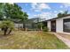 Well-maintained backyard featuring a screened pool and outdoor kitchen area at 316 Amanda Ln, Leesburg, FL 34748