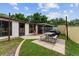 Backyard featuring a cozy patio with a picnic table, perfect for outdoor dining and entertaining at 316 Amanda Ln, Leesburg, FL 34748