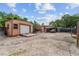 Spacious backyard featuring storage sheds, gravel, and an enclosed fence area at 316 Amanda Ln, Leesburg, FL 34748
