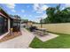 Backyard featuring a cozy patio with a picnic table, perfect for outdoor dining and entertaining at 316 Amanda Ln, Leesburg, FL 34748