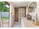Bathroom featuring a shower, white vanity, and an exterior entrance at 316 Amanda Ln, Leesburg, FL 34748