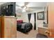 Bedroom featuring a ceiling fan, neutral walls, a comfortable bed, and a TV on a dresser at 316 Amanda Ln, Leesburg, FL 34748