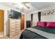 Bedroom with a ceiling fan, closet, dresser with a TV, and neutral decor at 316 Amanda Ln, Leesburg, FL 34748