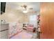 Charming Bedroom with pink and white decor, including a crib and changing table at 316 Amanda Ln, Leesburg, FL 34748
