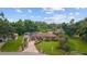 Charming single story home with a well-manicured front lawn and tropical landscaping at 316 Amanda Ln, Leesburg, FL 34748