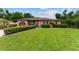 Charming home featuring a well-manicured lawn and shrubs, providing an inviting and attractive curb appeal at 316 Amanda Ln, Leesburg, FL 34748