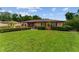 Well-maintained home with a green lawn, mature shrubs, and charming exterior details, offering inviting curb appeal at 316 Amanda Ln, Leesburg, FL 34748