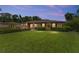 Charming home featuring a lush, manicured front lawn and mature landscaping, creating inviting curb appeal at 316 Amanda Ln, Leesburg, FL 34748