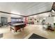 Spacious game room featuring a pool table, multiple seating areas, and plenty of natural light at 316 Amanda Ln, Leesburg, FL 34748