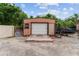 Exterior of single garage with siding and white door; includes small windows at 316 Amanda Ln, Leesburg, FL 34748