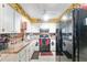 Kitchen features white cabinets and appliances at 316 Amanda Ln, Leesburg, FL 34748