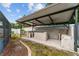 Outdoor kitchen with concrete block construction and ceiling fans at 316 Amanda Ln, Leesburg, FL 34748