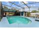 Inviting screened-in pool with a large deck, offering a perfect space for relaxation and recreation at 316 Amanda Ln, Leesburg, FL 34748