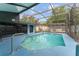Enclosed pool featuring cool blue tiling, metal railing, and screened-in patio at 316 Amanda Ln, Leesburg, FL 34748