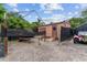 Exterior angle view of backyard shed with small door and awning support at 316 Amanda Ln, Leesburg, FL 34748