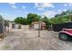 View of sheds, old car and yard storage on a gravel lot at 316 Amanda Ln, Leesburg, FL 34748