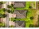 Overhead view captures residences with brick driveways, green lawns and tree-lined streets at 31924 Geoff, Sorrento, FL 32776