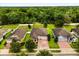 Aerial view showing homes featuring brick driveways, lush lawns, and mature trees at 31924 Geoff, Sorrento, FL 32776