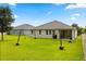 A spacious backyard featuring string lights, lush green grass, and a privacy fence at 31924 Geoff, Sorrento, FL 32776