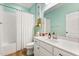 Bright bathroom with a shower-tub combo and white vanity with a large mirror and wood-look floors at 31924 Geoff, Sorrento, FL 32776