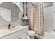 Charming bathroom with a vanity, decorative mirror, bathtub with shower, and stylish accents at 31924 Geoff, Sorrento, FL 32776