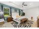 A luxurious bedroom featuring a tray ceiling, modern furniture, and a ceiling fan at 31924 Geoff, Sorrento, FL 32776
