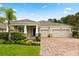 Charming single-story home with a three-car garage and well-manicured landscaping at 31924 Geoff, Sorrento, FL 32776