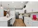 Bright kitchen with white cabinets, stainless steel appliances, quartz countertops, and wood-look tile flooring at 31924 Geoff, Sorrento, FL 32776