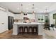Modern kitchen featuring a large island with seating, pendant lighting, and stainless steel appliances at 31924 Geoff, Sorrento, FL 32776