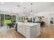 Open-concept kitchen with a farmhouse sink, stainless steel appliances, and a seamless flow to living spaces at 31924 Geoff, Sorrento, FL 32776