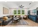 Cozy living room with a sectional sofa, modern fan, and bright natural light at 31924 Geoff, Sorrento, FL 32776