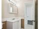 Neutral bathroom featuring a white vanity with a medicine cabinet and a door to the toilet at 3226 Midnight Star Ct, Kissimmee, FL 34744