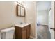 Bathroom featuring a single sink vanity, wood cabinets, and a mirrored medicine cabinet at 3226 Midnight Star Ct, Kissimmee, FL 34744