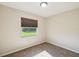 Cozy bedroom featuring neutral walls, carpeted floors, and a window with view of the yard at 3226 Midnight Star Ct, Kissimmee, FL 34744