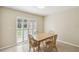 Cozy dining area featuring natural light and a wooden table with four chairs at 3226 Midnight Star Ct, Kissimmee, FL 34744