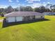 Exterior view of the home featuring an attached two-car garage and a large front yard at 3226 Midnight Star Ct, Kissimmee, FL 34744