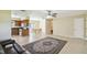 Bright living room with open layout to the kitchen and dining area, tiled floors and neutral paint at 3226 Midnight Star Ct, Kissimmee, FL 34744