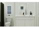 Bathroom featuring a framed mirror and a clean, white vanity with ample storage space at 349 Sol Vista Dr, Dundee, FL 33838