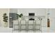 Bright kitchen boasts white cabinets, stainless appliances, and island seating at 349 Sol Vista Dr, Dundee, FL 33838