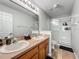 Bathroom features a double sink vanity, large mirror, and shower with glass doors at 3599 Caruso Pl, Oviedo, FL 32765
