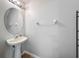 This bathroom features a pedestal sink, oval mirror, and modern fixtures at 3599 Caruso Pl, Oviedo, FL 32765