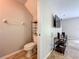 A half-bath is visible from the living room, with a toilet and shelving unit at 3599 Caruso Pl, Oviedo, FL 32765