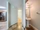 Bathroom with pedestal sink, adjacent to the kitchen featuring tile flooring and stainless steel refrigerator at 3599 Caruso Pl, Oviedo, FL 32765