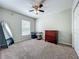 Cozy bedroom with natural light, carpeting, dresser, and a desk with storage at 3599 Caruso Pl, Oviedo, FL 32765
